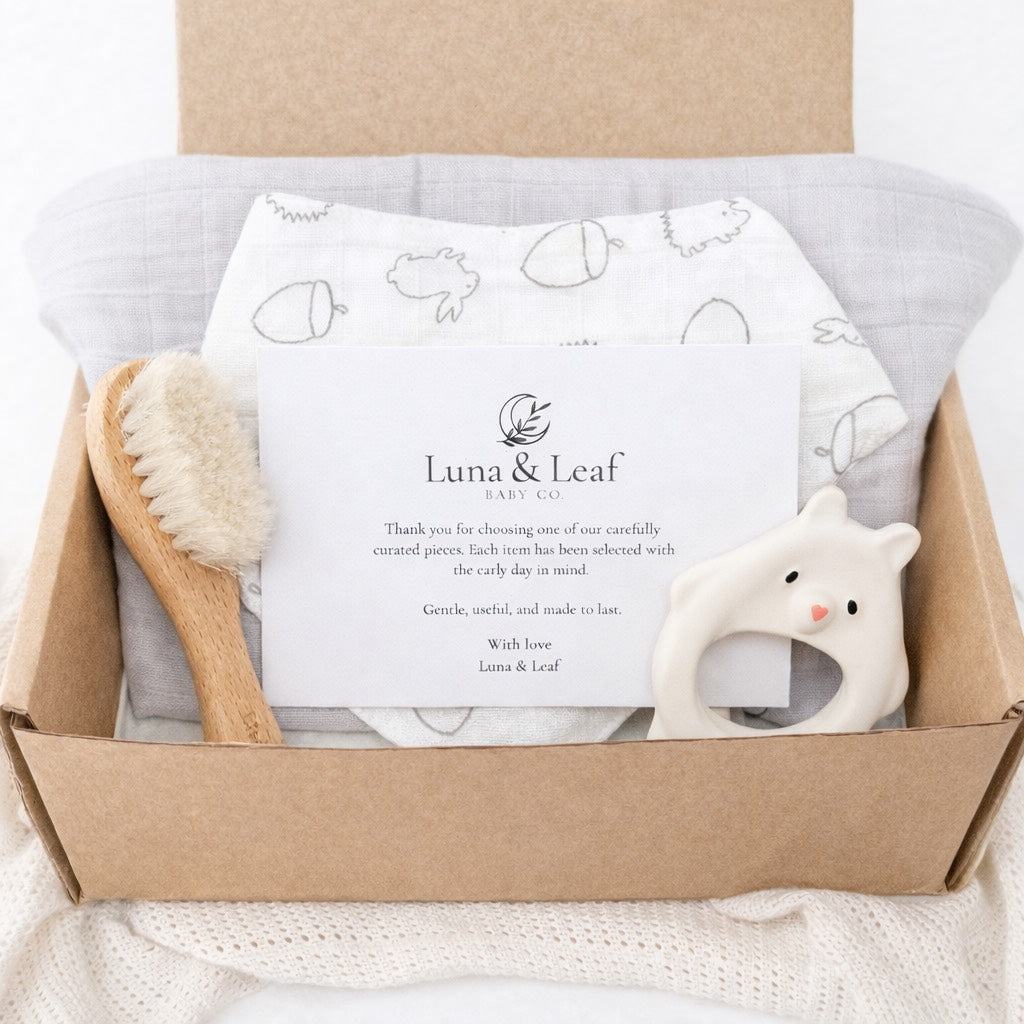 Essentials baby bundle with neutral muslin cloth, dribble bib, natural rubber teether and goat hair brush