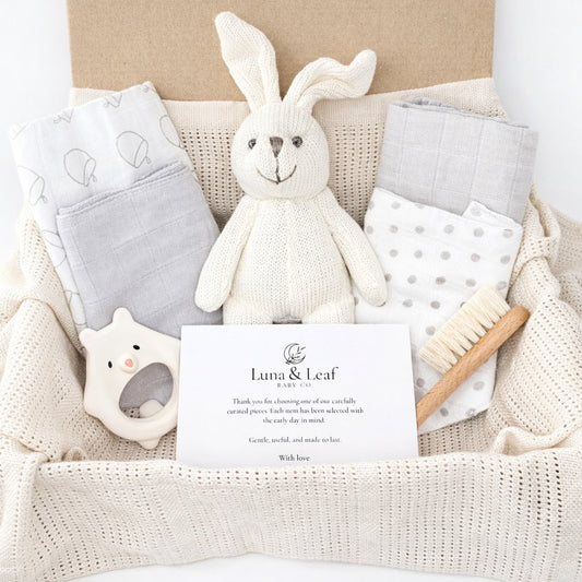 Premium baby gift bundle with muslin cloths, bibs, natural teether, goat hair brush, bunny rattle and cellular blanket
